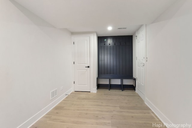 mudroom with baseboards, light wood-style flooring, and recessed lighting