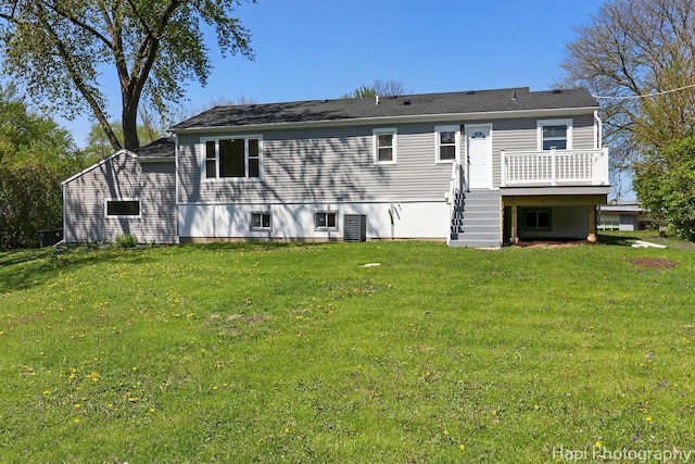 back of house with a deck, a yard, and stairway