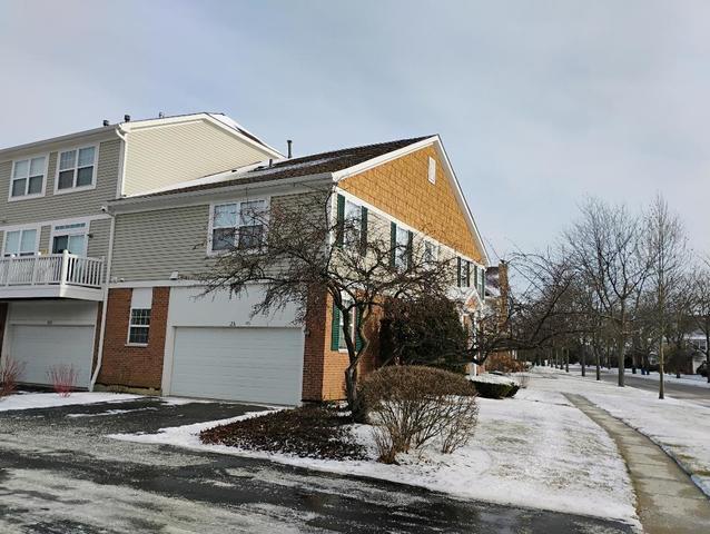 view of snowy exterior featuring a garage