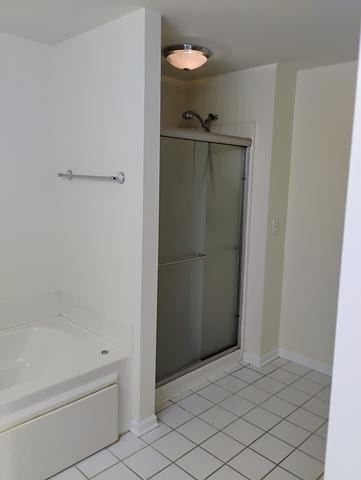 bathroom featuring shower with separate bathtub and tile patterned floors