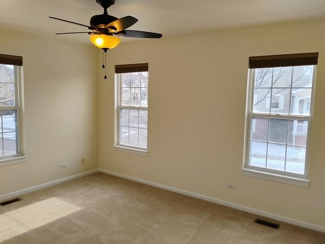 empty room with light carpet and ceiling fan