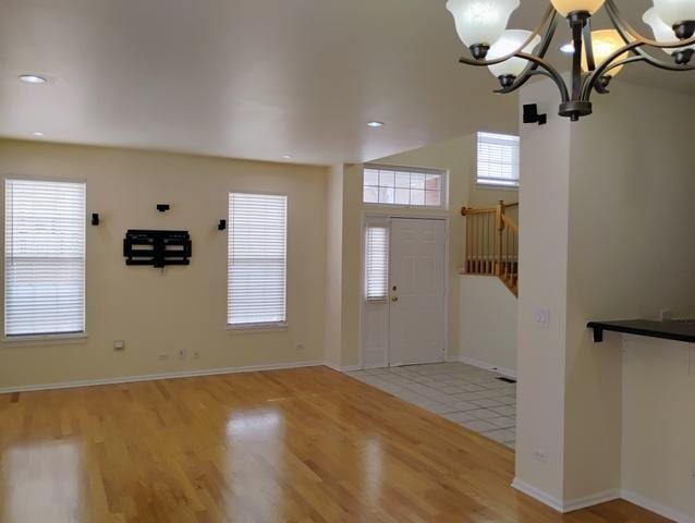 foyer with light hardwood / wood-style flooring and a notable chandelier