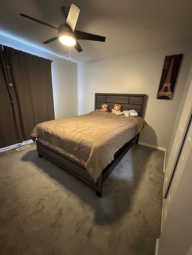 bedroom featuring ceiling fan and carpet