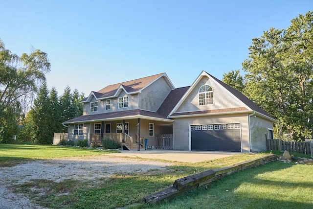 view of front facade with a porch, a garage, and a front lawn