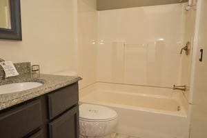 full bathroom with shower / bathtub combination, vanity, and toilet