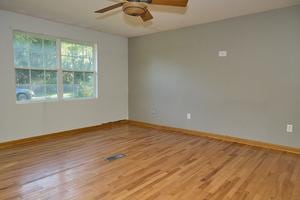 unfurnished room featuring ceiling fan and hardwood / wood-style floors