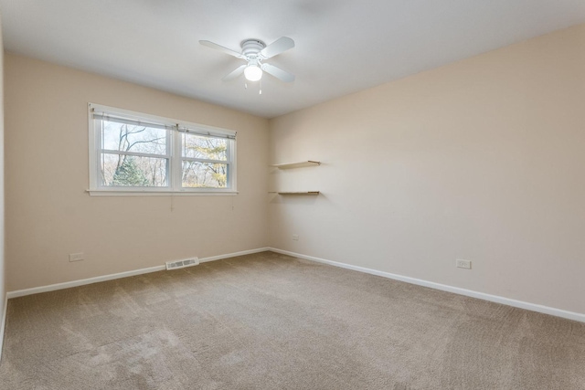 spare room with visible vents, ceiling fan, baseboards, and carpet floors