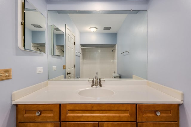 full bath featuring visible vents, toilet, walk in shower, and vanity