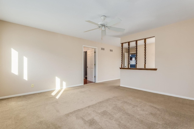 carpeted empty room featuring visible vents, ceiling fan, and baseboards