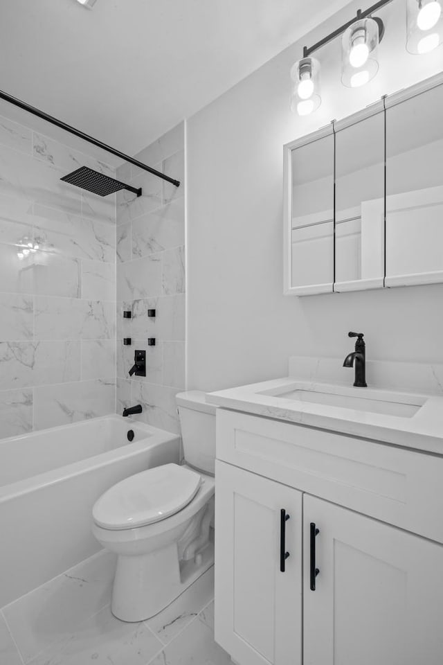 full bathroom featuring tiled shower / bath, vanity, and toilet