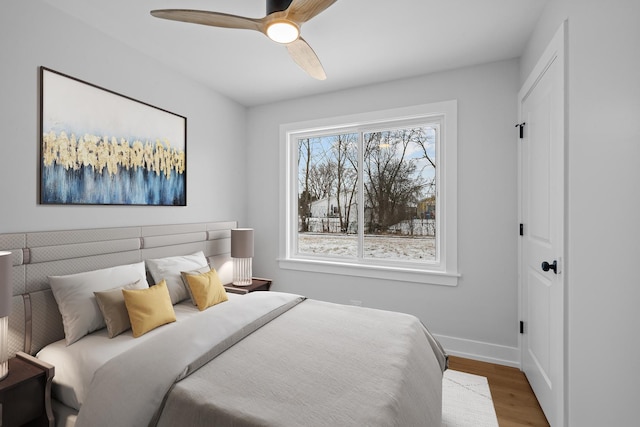 bedroom featuring hardwood / wood-style flooring and ceiling fan