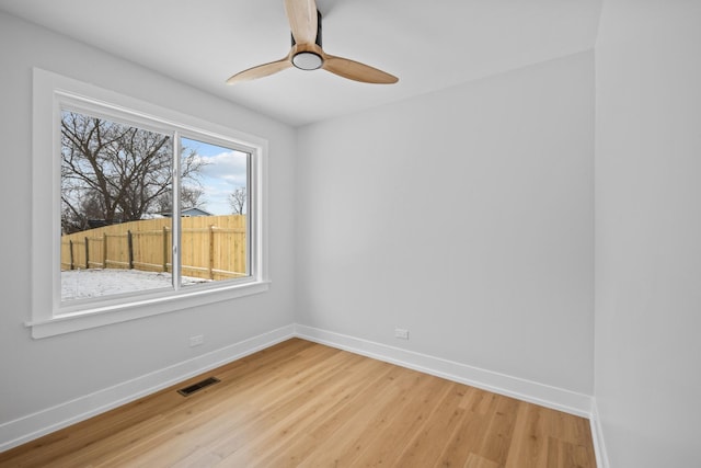 spare room featuring hardwood / wood-style flooring and ceiling fan