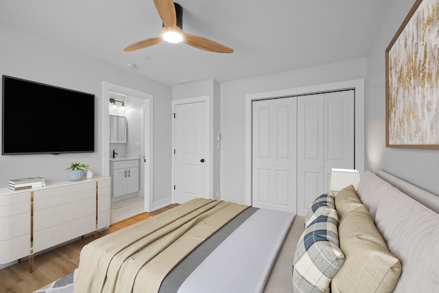 bedroom with ceiling fan, ensuite bathroom, light hardwood / wood-style floors, and a closet