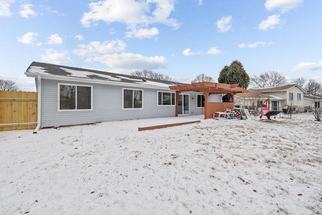 snow covered house featuring a pergola