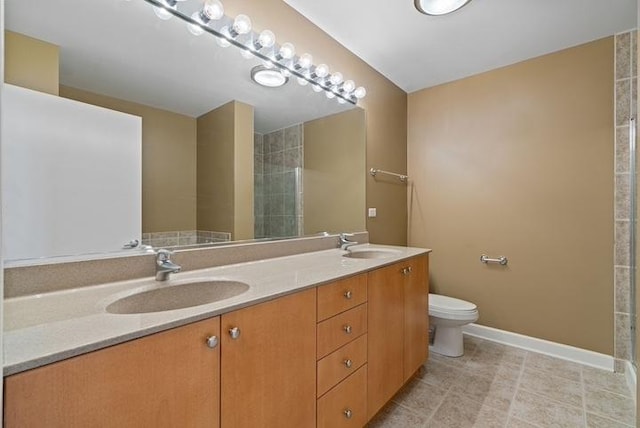 bathroom featuring vanity, an enclosed shower, and toilet