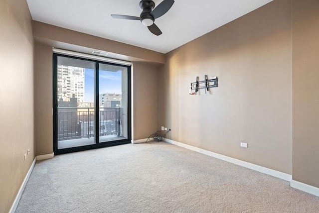 carpeted spare room with ceiling fan