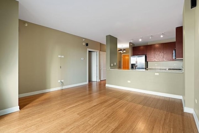 unfurnished living room with light hardwood / wood-style floors