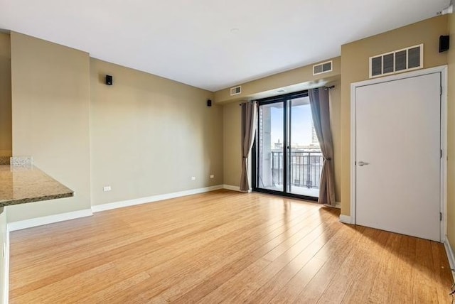 spare room with light wood-type flooring