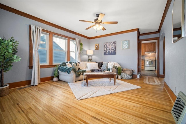 living room featuring ornamental molding, ceiling fan, and light wood-type flooring