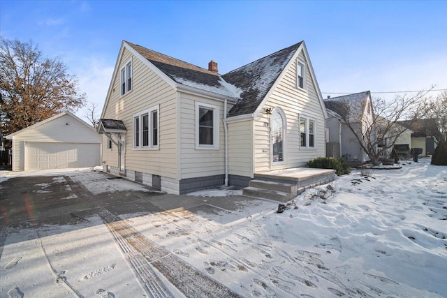 exterior space featuring a garage and an outbuilding