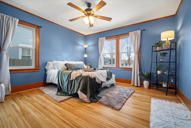 bedroom with crown molding, ceiling fan, and light wood-type flooring