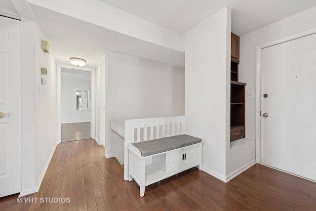 hallway with dark hardwood / wood-style flooring