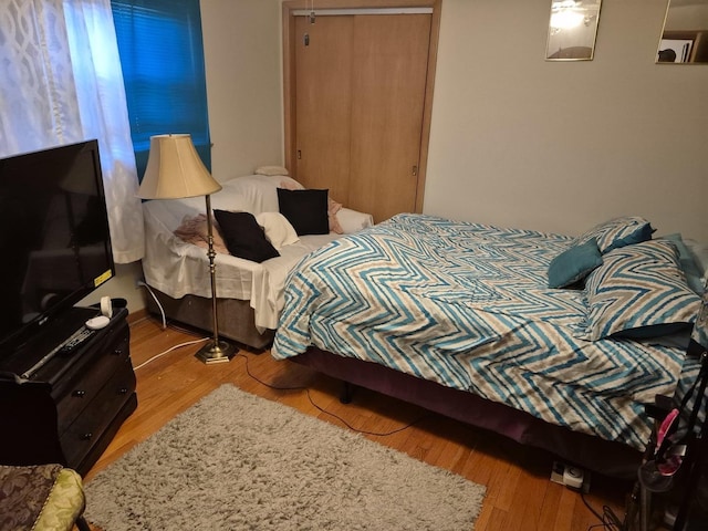 bedroom featuring light hardwood / wood-style floors and a closet