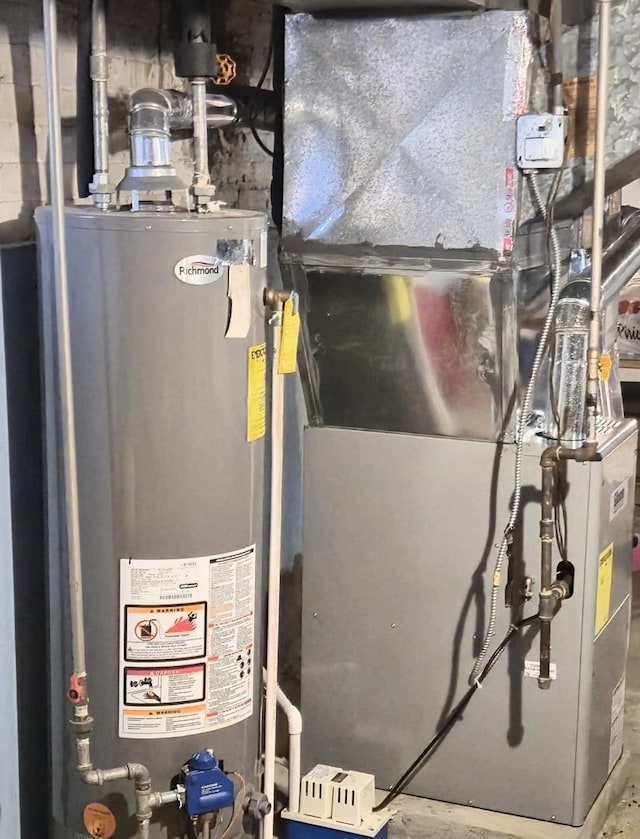 utility room featuring water heater and heating unit