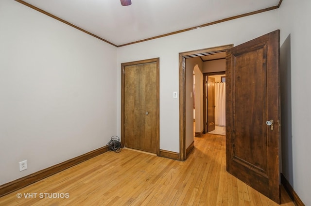 unfurnished bedroom featuring crown molding, ceiling fan, and light wood-type flooring