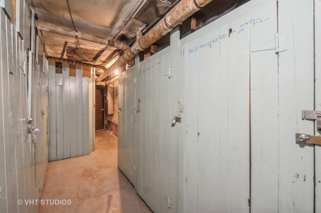 basement featuring wooden walls