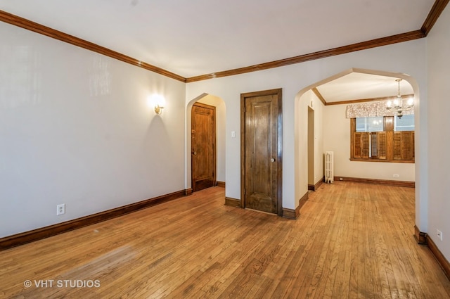 empty room featuring radiator, crown molding, and light hardwood / wood-style flooring