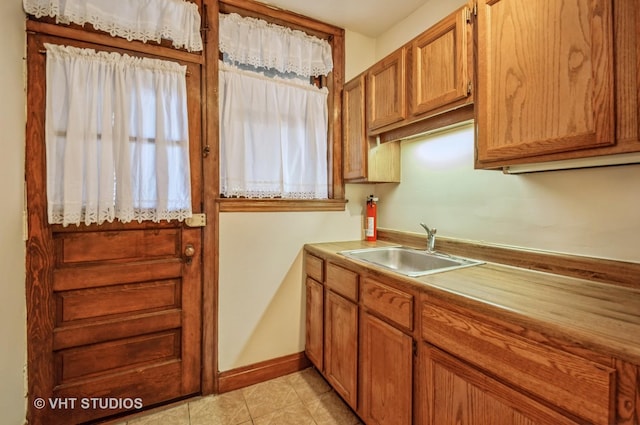 kitchen featuring sink and light tile patterned floors