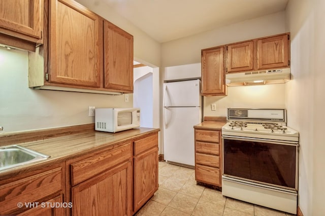 kitchen featuring sink and white appliances