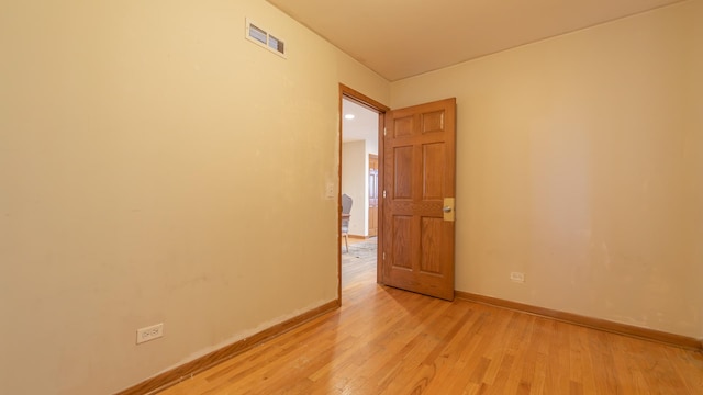 unfurnished room with light hardwood / wood-style flooring