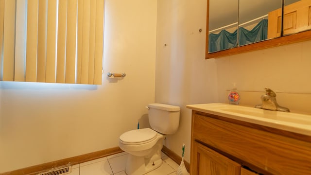 bathroom with tile patterned floors, toilet, and vanity