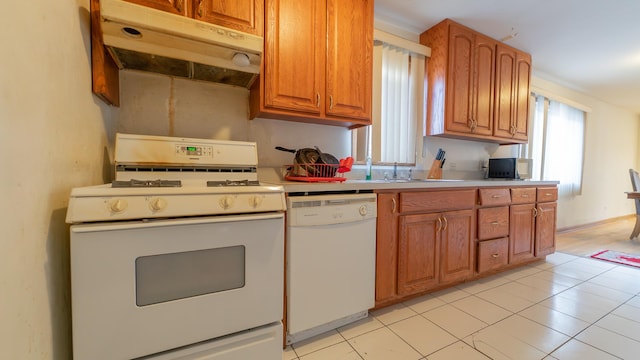 kitchen featuring white appliances and light tile patterned flooring