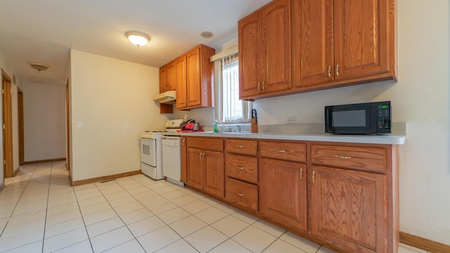 kitchen with light tile patterned flooring, sink, and white appliances