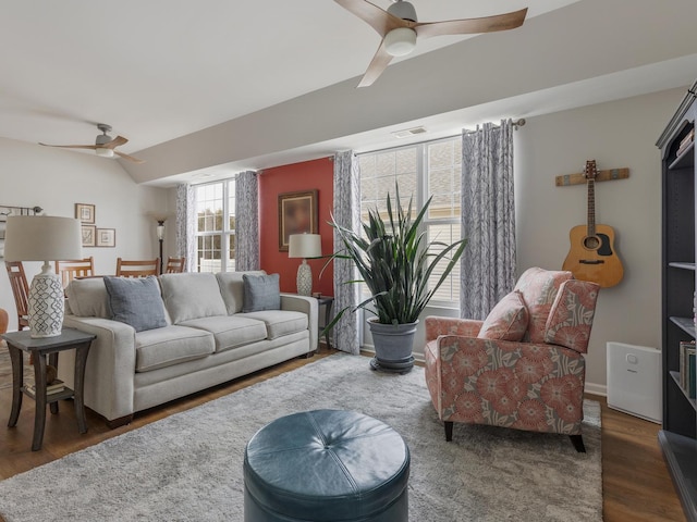 living room with dark wood-type flooring, ceiling fan, and vaulted ceiling