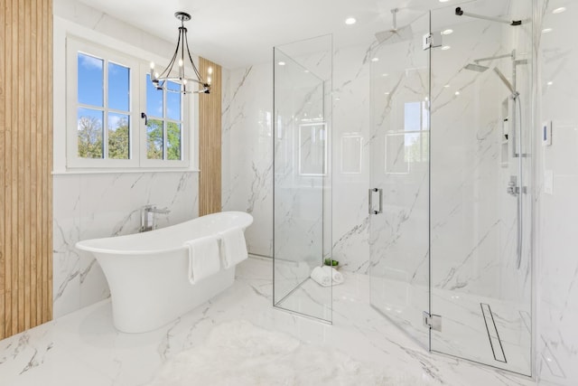 bathroom featuring a chandelier and separate shower and tub