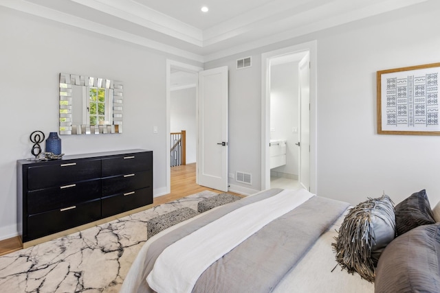 bedroom featuring ensuite bath and light hardwood / wood-style flooring