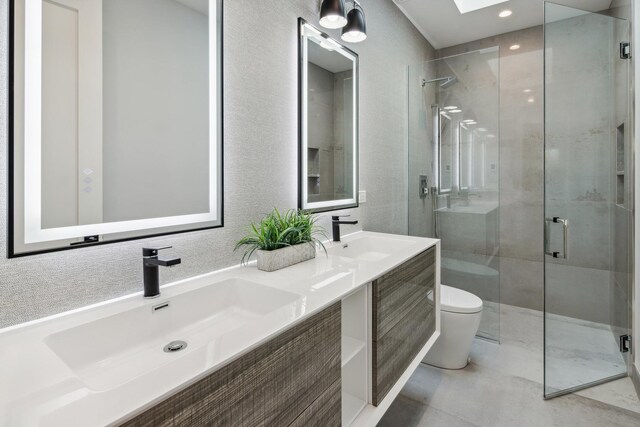 bathroom with vanity, an enclosed shower, a skylight, and toilet