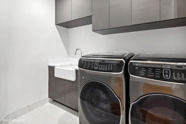 laundry area with cabinets and washing machine and clothes dryer