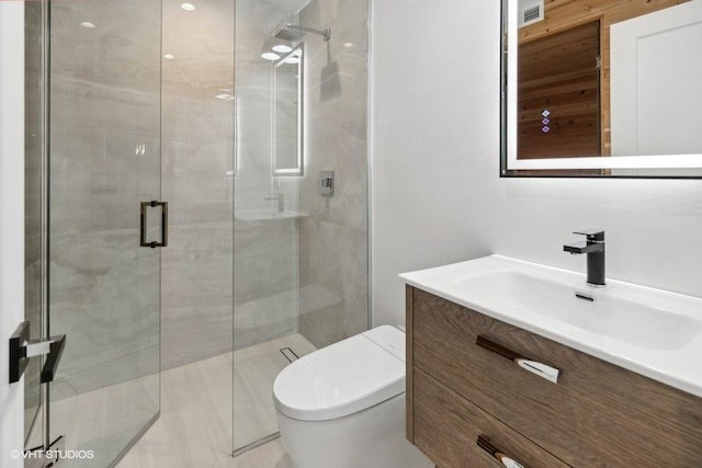 bathroom with vanity, an enclosed shower, and toilet