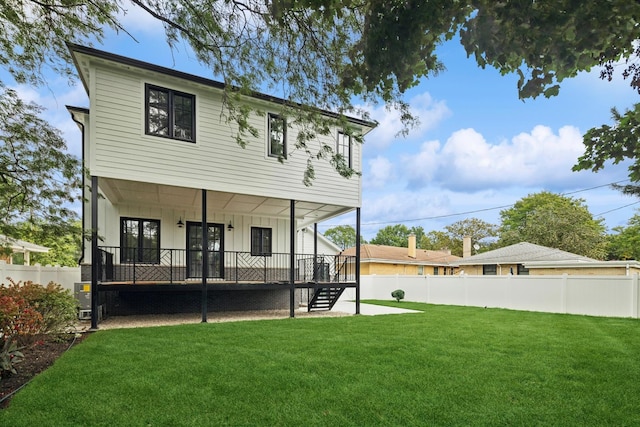 rear view of house with a lawn