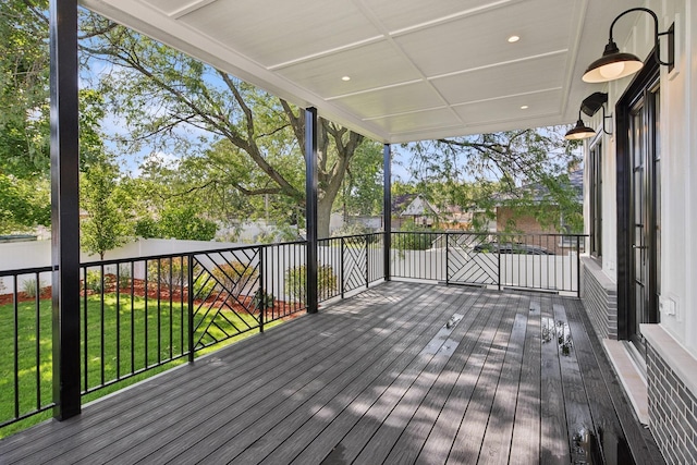 wooden terrace featuring a yard