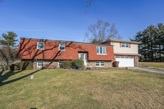 raised ranch featuring a garage and a front lawn