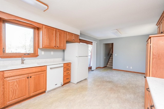 kitchen with white appliances and sink