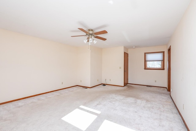 carpeted spare room with ceiling fan