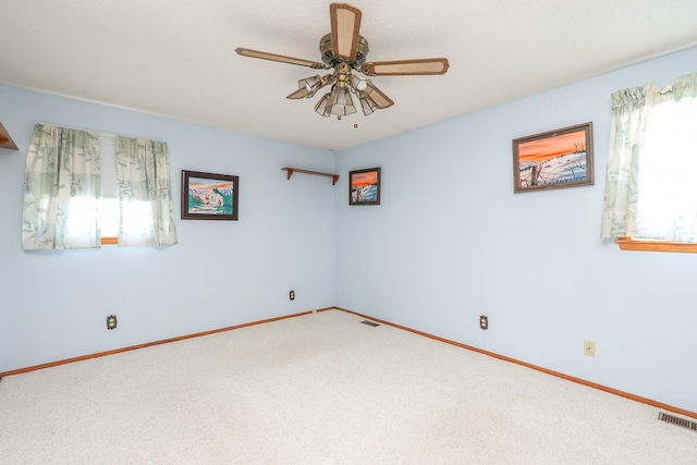 unfurnished room featuring ceiling fan and carpet