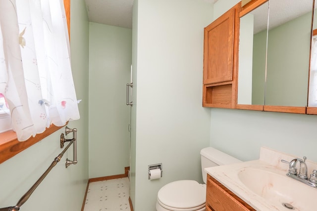 bathroom with vanity, a textured ceiling, and toilet